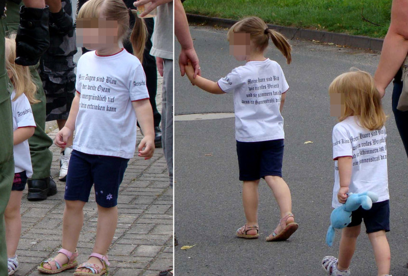 Der Spruch auf diesem Kinder-Shirt zitiert fast originalgetreu eine Strophe des Liedes »Arisches Kind«  der Band Landser. Im Lied heißt es: »Deine Augen, die sind blau wie der weite Ozean und so unergründlich tief, dass man drin ertrinken kann. Deine Haare, die sind blond wie eine reifes Weizenfeld und sie schimmern fast wie Gold, wenn ein Sonnenstrahl drauf fällt.«